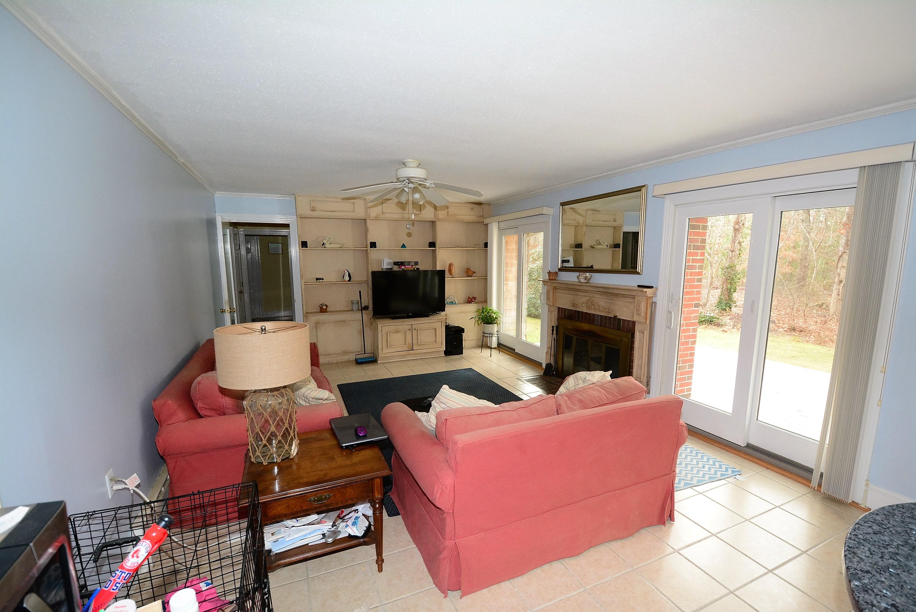 64 Depot Road Cataumet, MA 02534 - Photo 8 of 26 a living room with furniture a flat screen tv and a fireplace