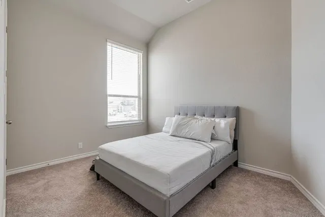 a bedroom with a bed and window