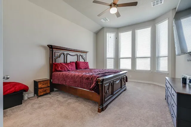 a bed sitting in a room next to a window