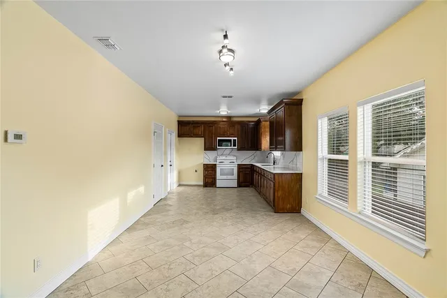 a view of a kitchen with furniture and windows