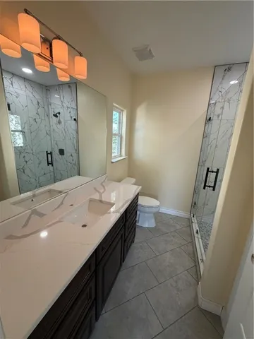 a spacious bathroom with a double vanity sink and a mirror