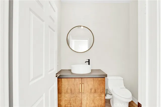 a bathroom with a toilet sink and mirror