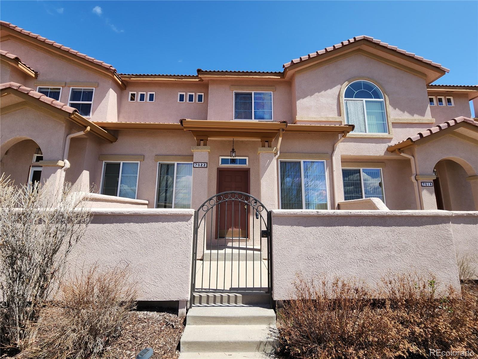 7022 Sand Crest View Colorado Springs, CO 80923 - Photo 1 of 16 front view of a house with a street