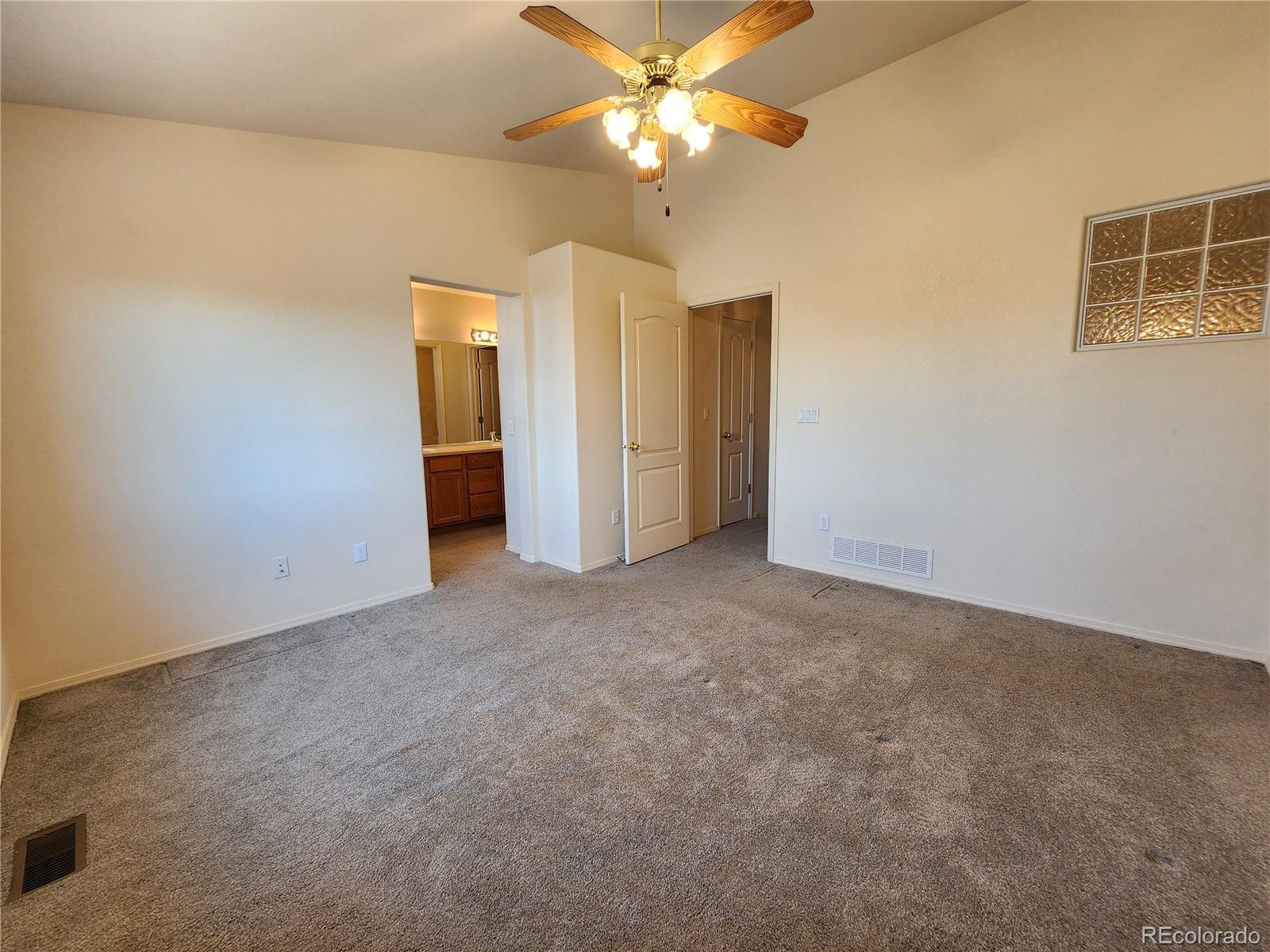 7022 Sand Crest View Colorado Springs, CO 80923 - Photo 13 of 16 a view of a big room with windows and chandelier fan