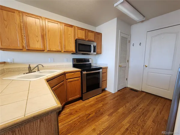 a kitchen with a sink a stove and a microwave