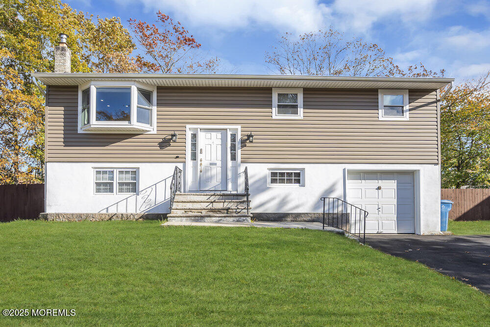 117 Manhattan Street Jackson, NJ 08527 - Photo 1 of 31 a front view of a house with a garden and yard