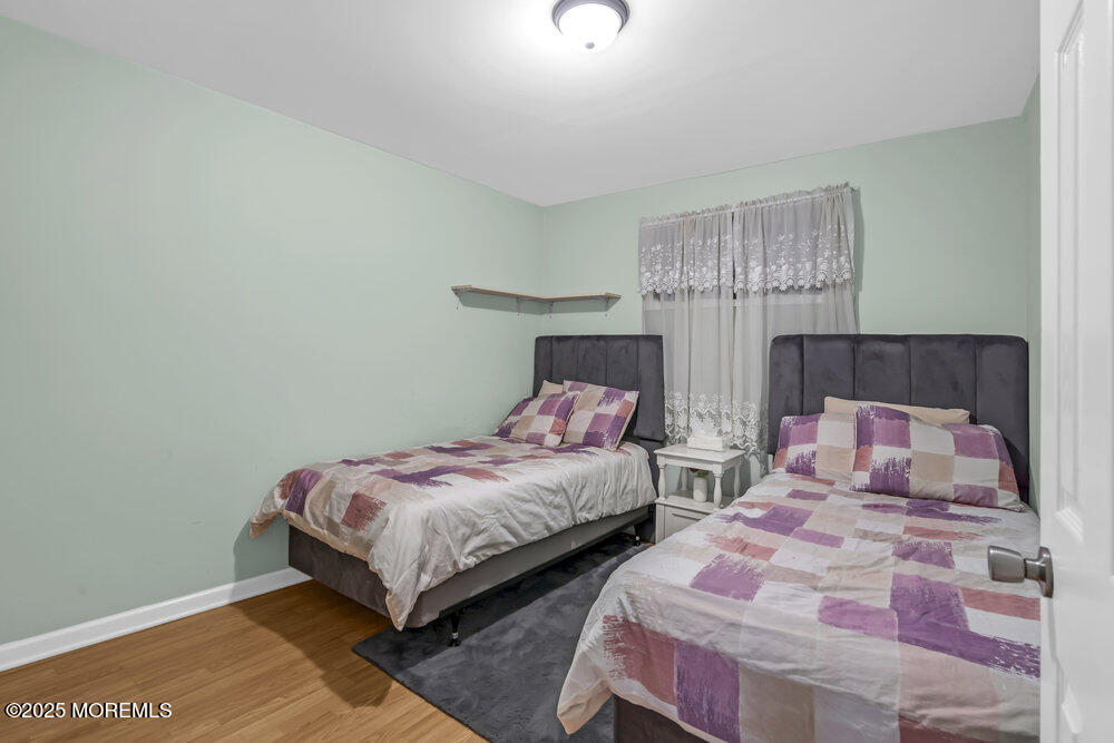 117 Manhattan Street Jackson, NJ 08527 - Photo 18 of 31 a bedroom with two beds and a chandelier