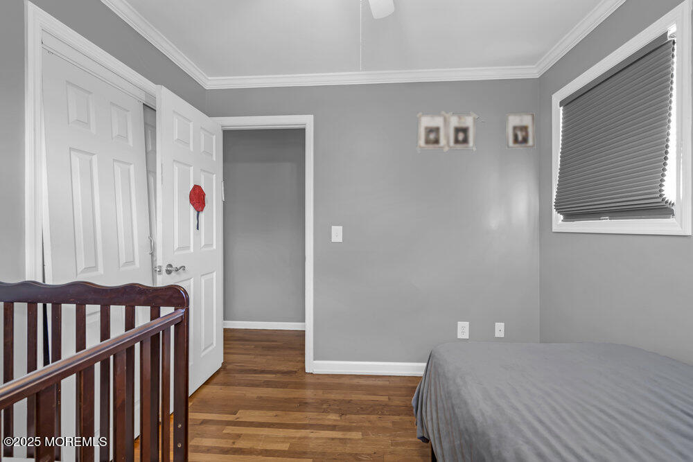 117 Manhattan Street Jackson, NJ 08527 - Photo 20 of 31 a bedroom with a bed and wooden floor