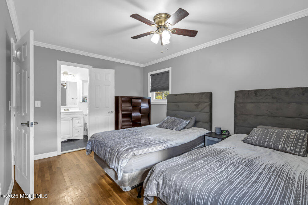 117 Manhattan Street Jackson, NJ 08527 - Photo 22 of 31 a bedroom with two large bed and a chandelier