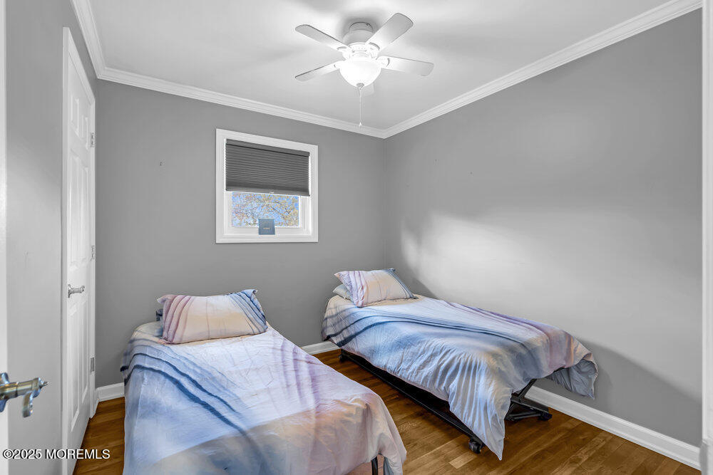 117 Manhattan Street Jackson, NJ 08527 - Photo 24 of 31 a bedroom with two beds and a chandelier