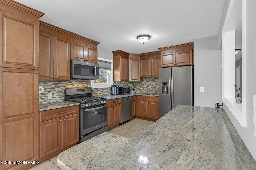 117 Manhattan Street Jackson, NJ 08527 - Photo 10 of 31 a kitchen with stainless steel appliances granite countertop a refrigerator stove top oven a sink and dishwasher