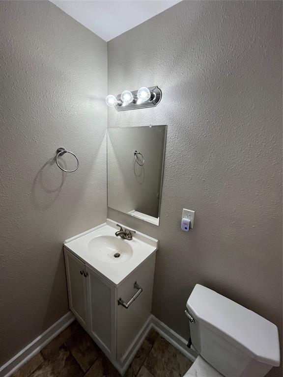 3006 Chiesa Road Rowlett, TX 75088 - Photo 19 of 33 a bathroom with a toilet sink and mirror