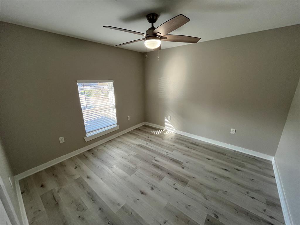 3006 Chiesa Road Rowlett, TX 75088 - Photo 20 of 33 an empty room with wooden floor and windows