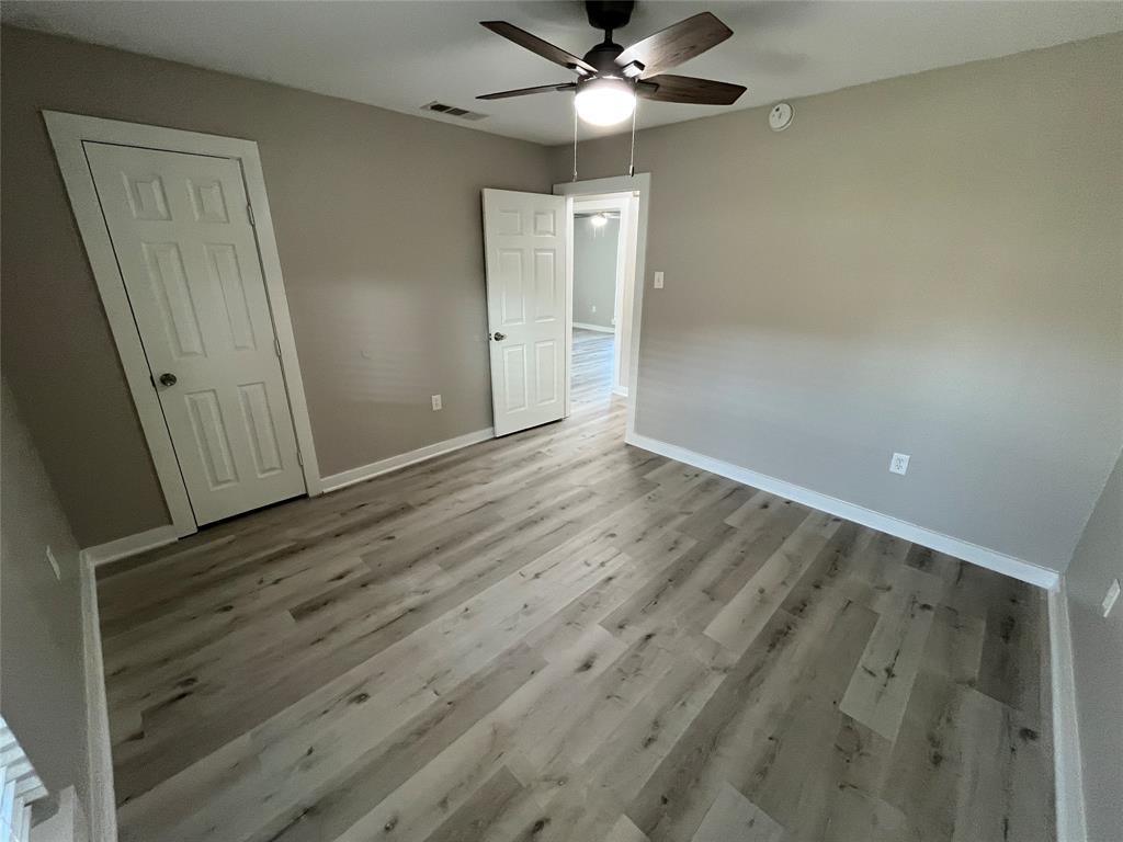 3006 Chiesa Road Rowlett, TX 75088 - Photo 24 of 33 an empty room with wooden floor fan and windows