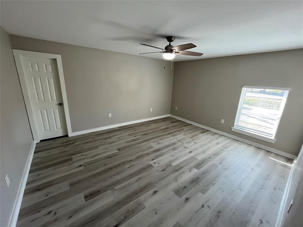 3006 Chiesa Road Rowlett, TX 75088 - Photo 25 of 33 a view of an empty room with wooden floor and a window