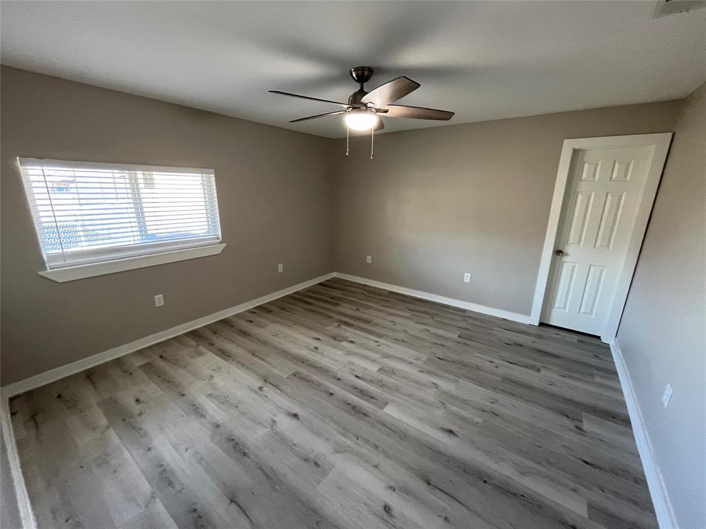 3006 Chiesa Road Rowlett, TX 75088 - Photo 27 of 33 an empty room with wooden floor fan and windows