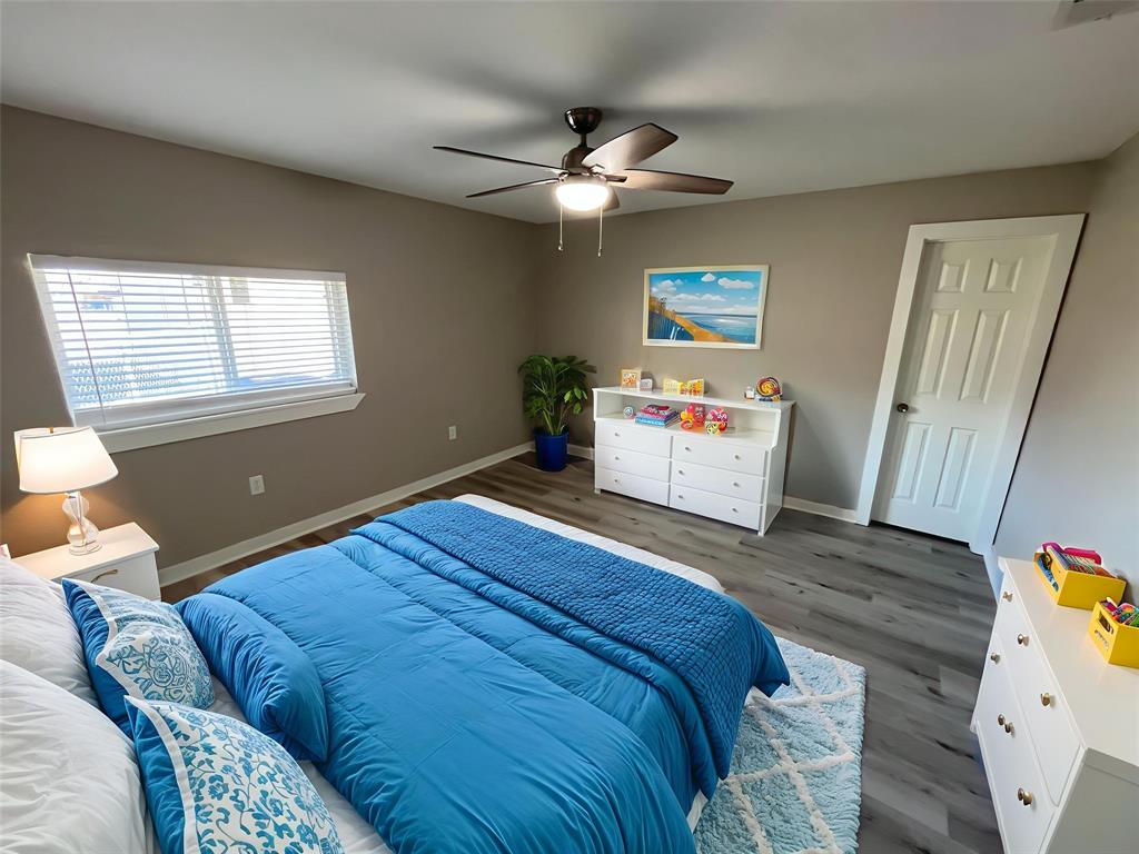 3006 Chiesa Road Rowlett, TX 75088 - Photo 28 of 33 a bedroom with a bed and wooden floor