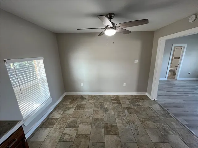 a kitchen with granite countertop a refrigerator and a sink