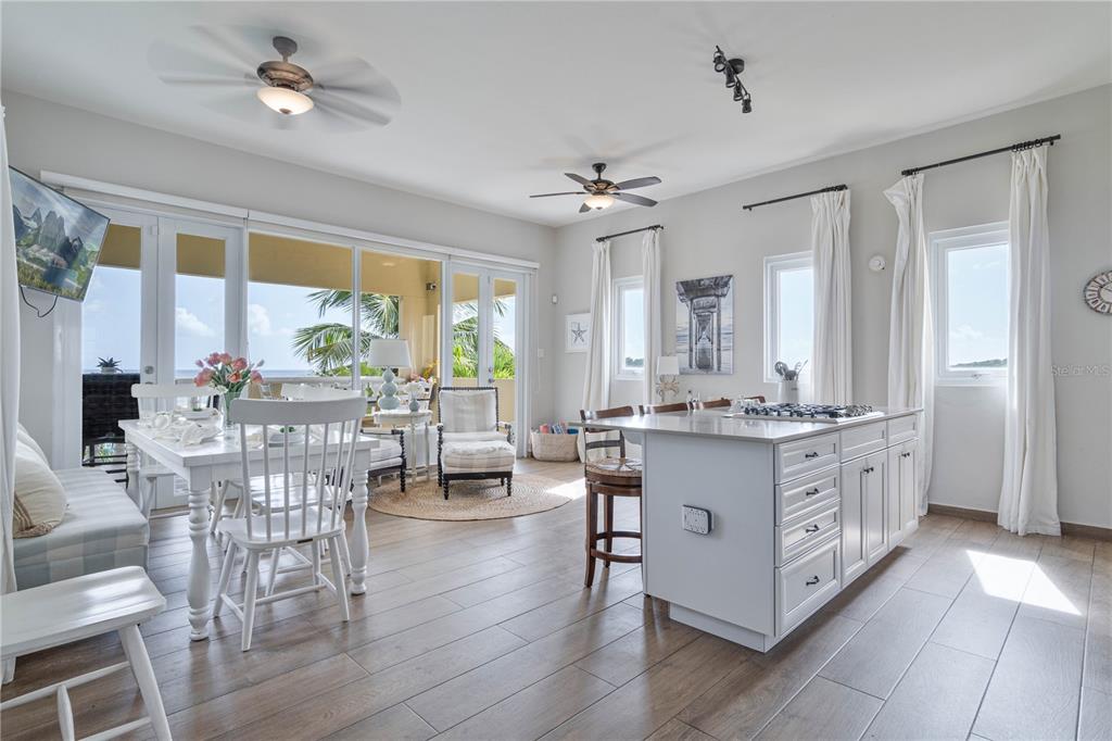 53 Shell Castle Road Humacao, Humacao 00791 - Photo 13 of 22 a large kitchen with kitchen island granite countertop a large window and white cabinets