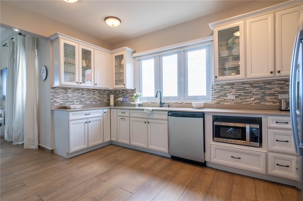 53 Shell Castle Road Humacao, Humacao 00791 - Photo 20 of 22 a kitchen with granite countertop white cabinets and white appliances