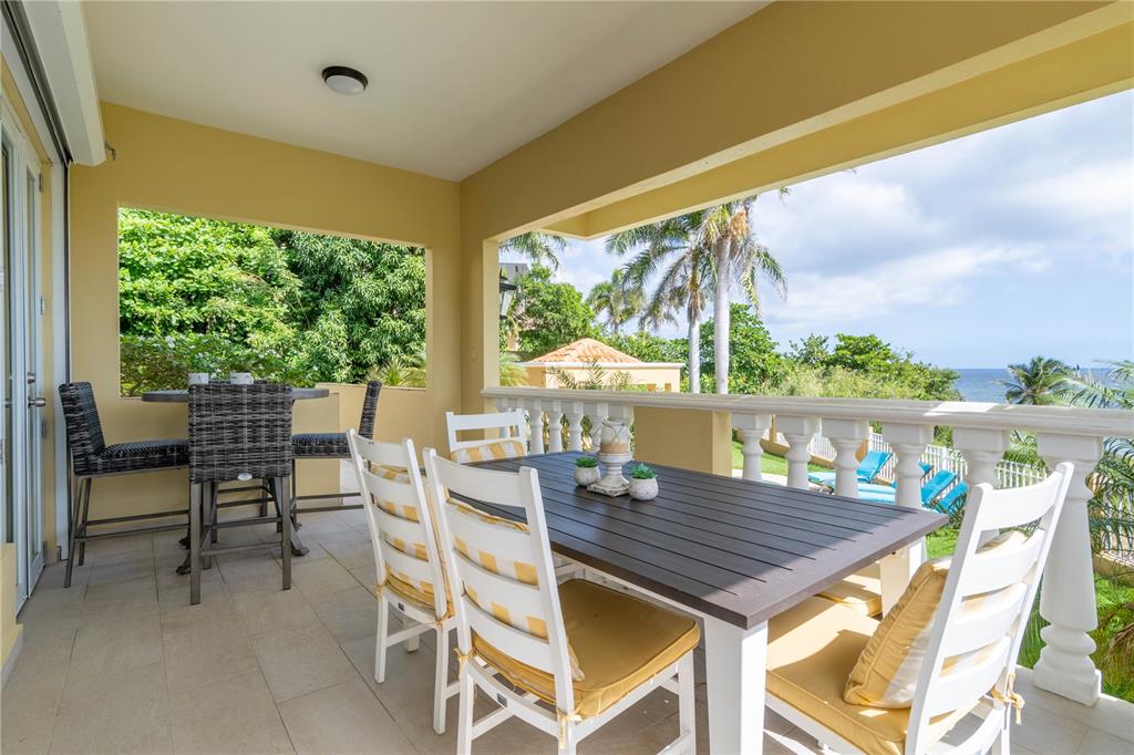 53 Shell Castle Road Humacao, Humacao 00791 - Photo 22 of 22 a view of a patio with a table chairs and a patio