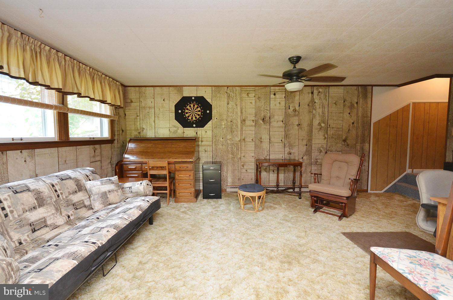1008 South Hoga Road Sterling, VA 20164 - Photo 22 of 30 a living room with furniture a fireplace and a large window