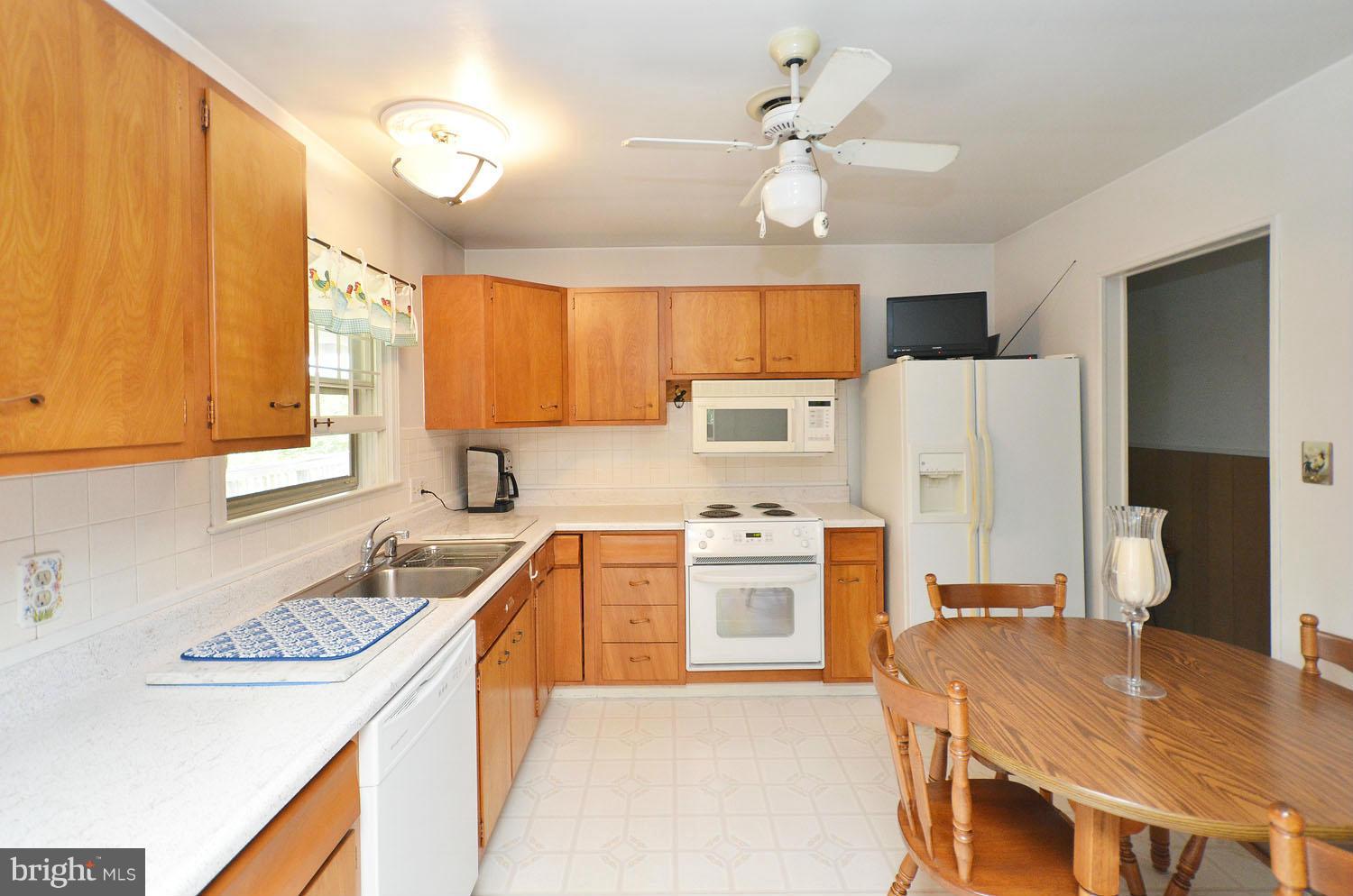 1008 South Hoga Road Sterling, VA 20164 - Photo 8 of 30 a kitchen with stainless steel appliances granite countertop a sink stove and refrigerator