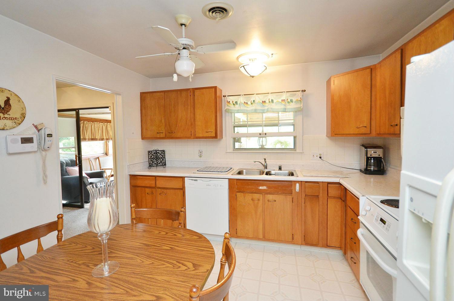 1008 South Hoga Road Sterling, VA 20164 - Photo 9 of 30 a large kitchen with stainless steel appliances granite countertop a sink dishwasher a stove and a refrigerator with wooden floor