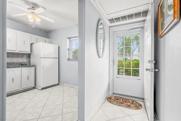 a kitchen with a refrigerator a stove top oven and cabinets