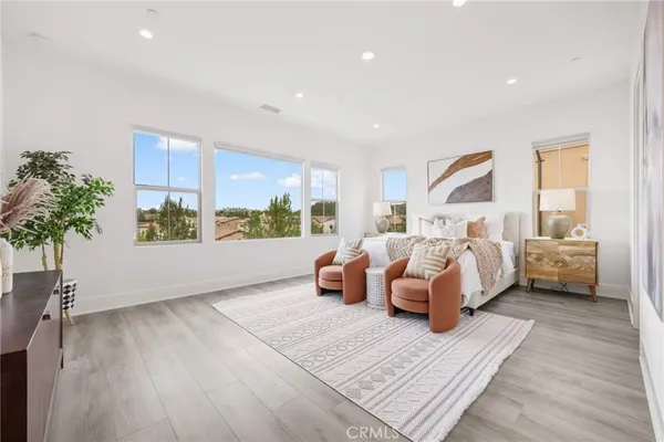 a bedroom with furniture and a large window