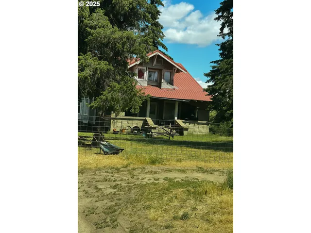 a view of a house with swimming pool and sitting area