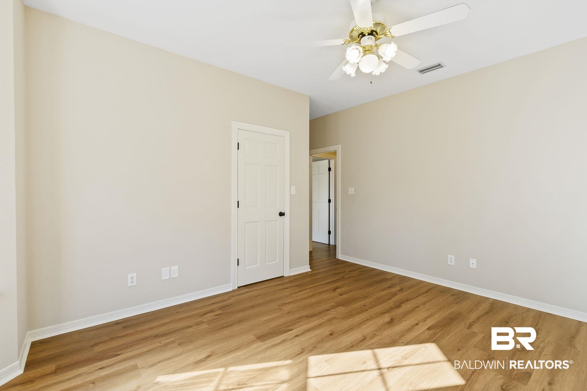 9631 Bay Meadows Avenue Fairhope, AL 36532 - Photo 25 of 49 Bedroom featuring ceiling fan, light hardwood / wood-style flooring, and walk in closet with shelving.