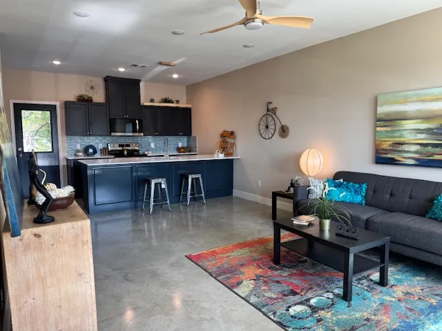 a living room with furniture and a dining table