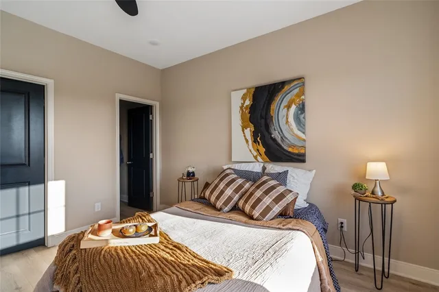 a bedroom with a bed and wooden floor
