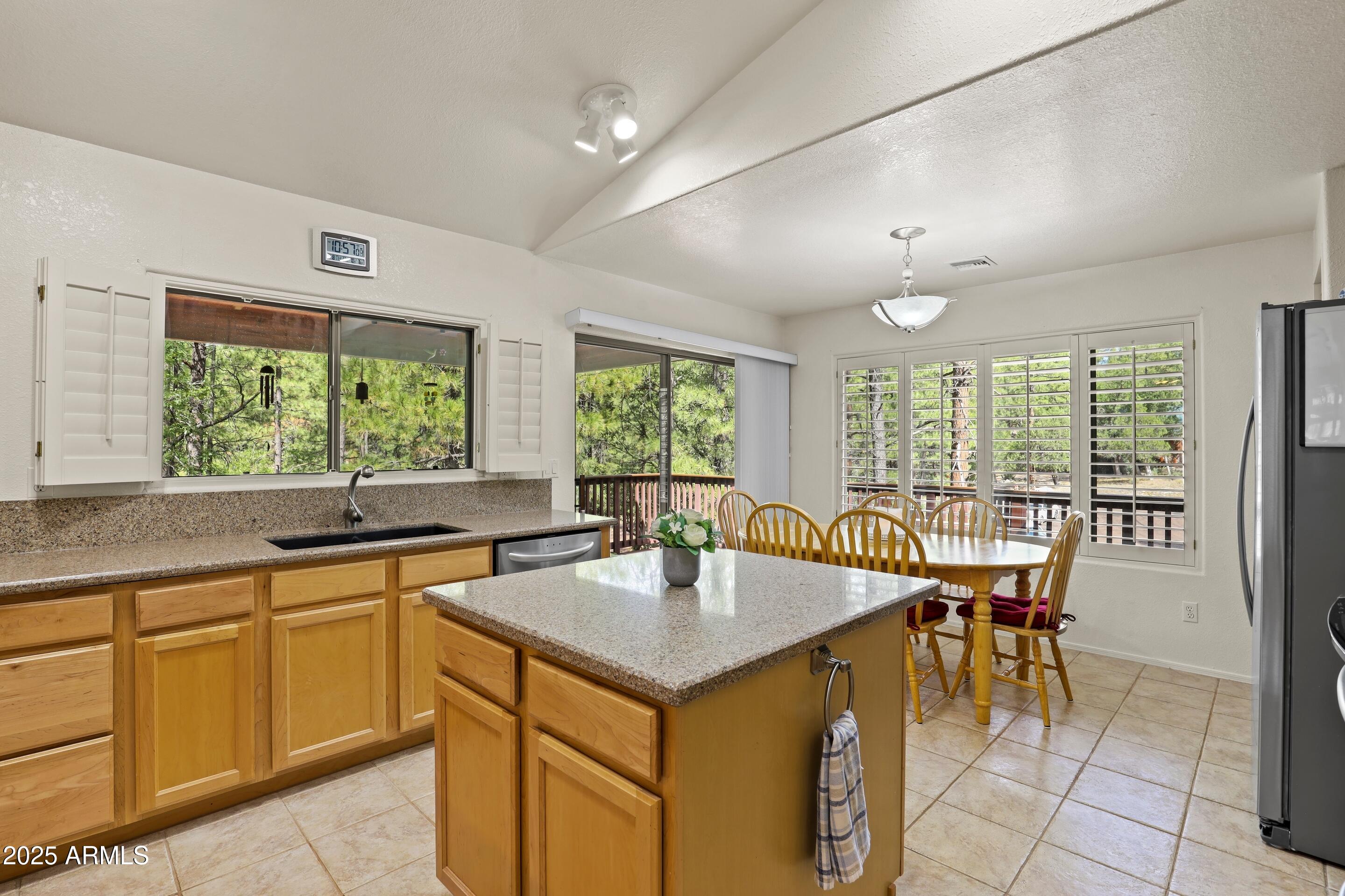 269 Homestead Lane Payson, AZ 85541 - Photo 18 of 38 a kitchen with a stove a sink a counter space and dining table