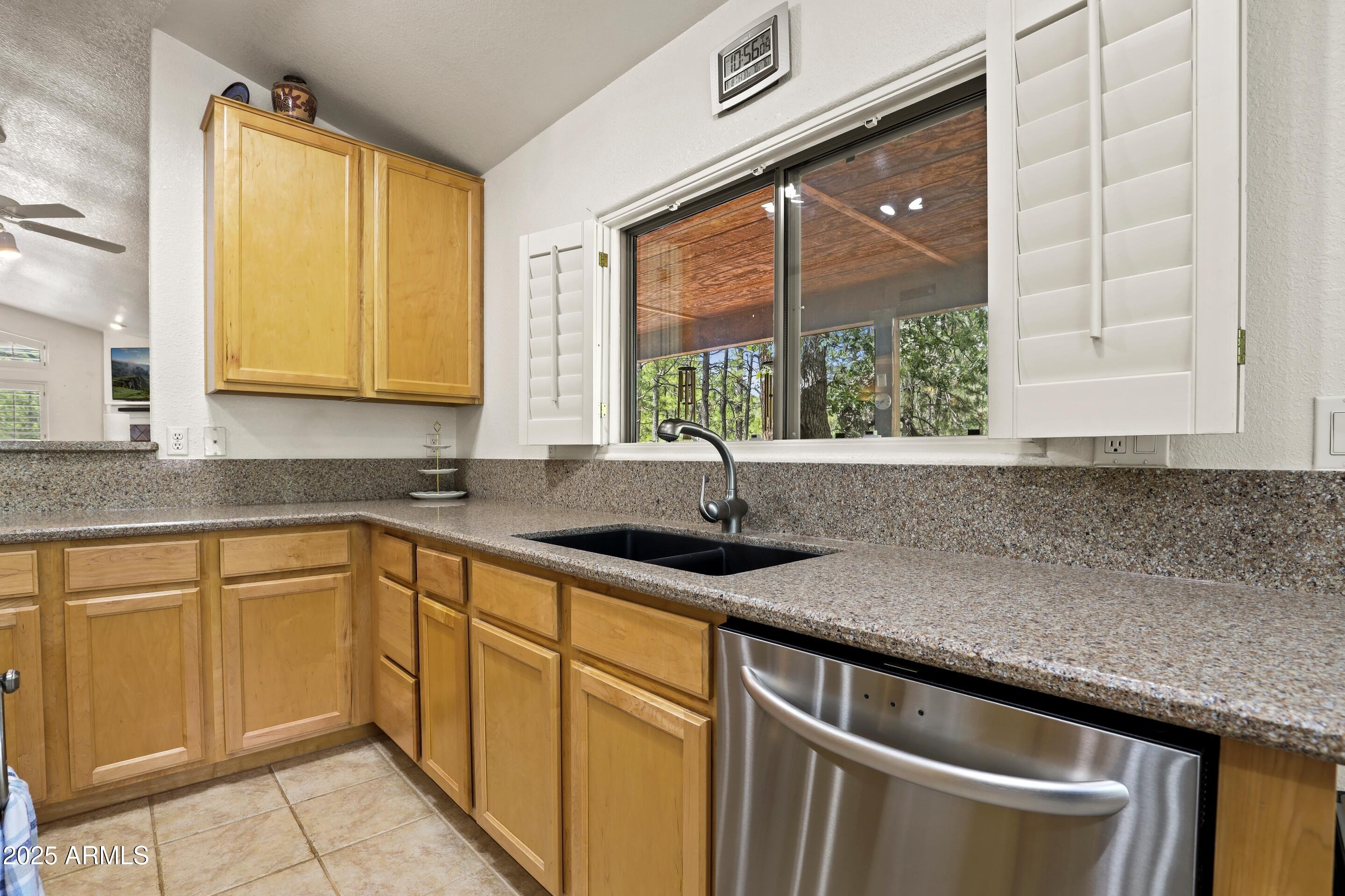 269 Homestead Lane Payson, AZ 85541 - Photo 21 of 38 a kitchen with granite countertop a sink and a window
