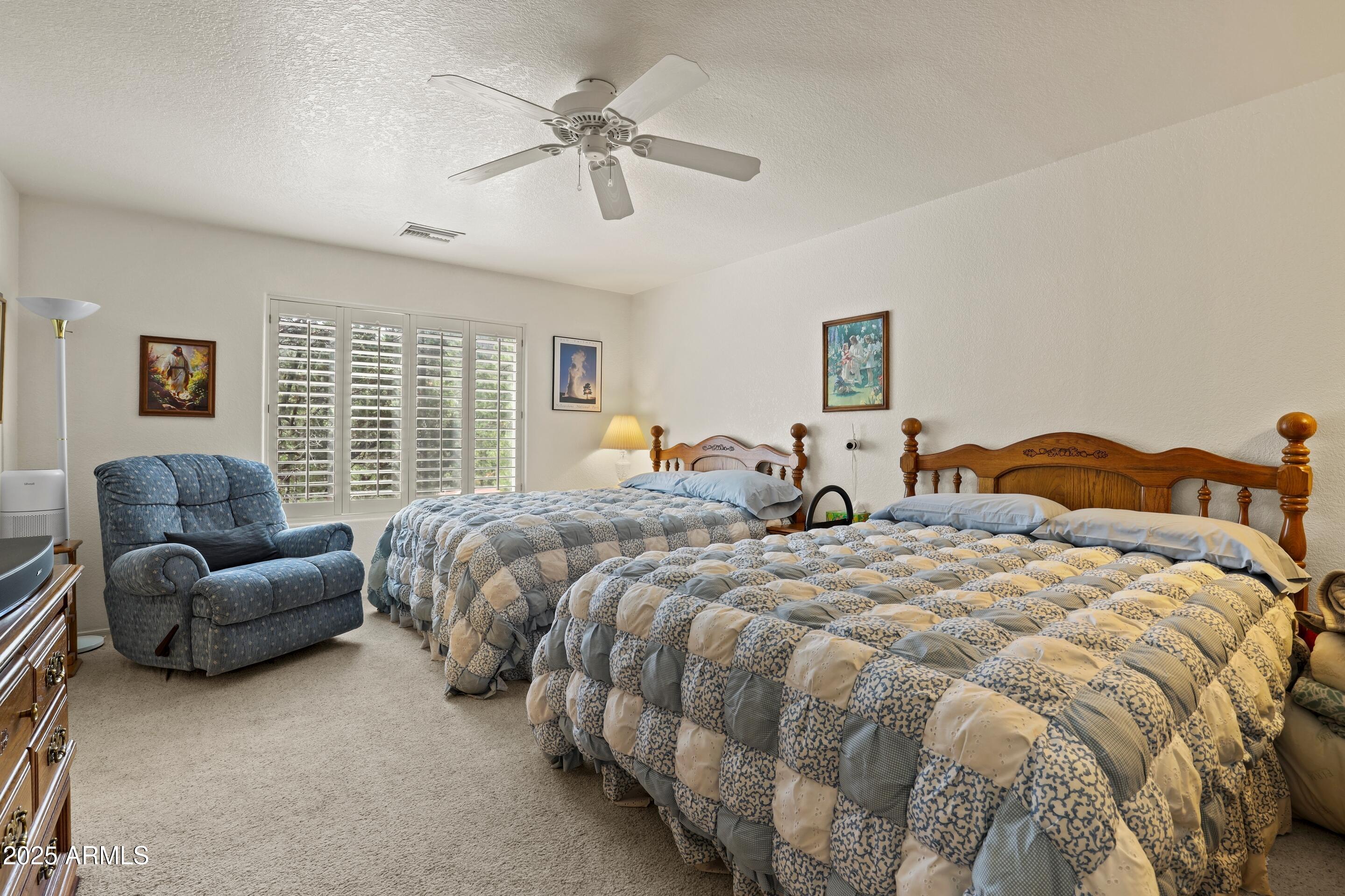269 Homestead Lane Payson, AZ 85541 - Photo 26 of 38 a spacious bedroom with two beds and a couch