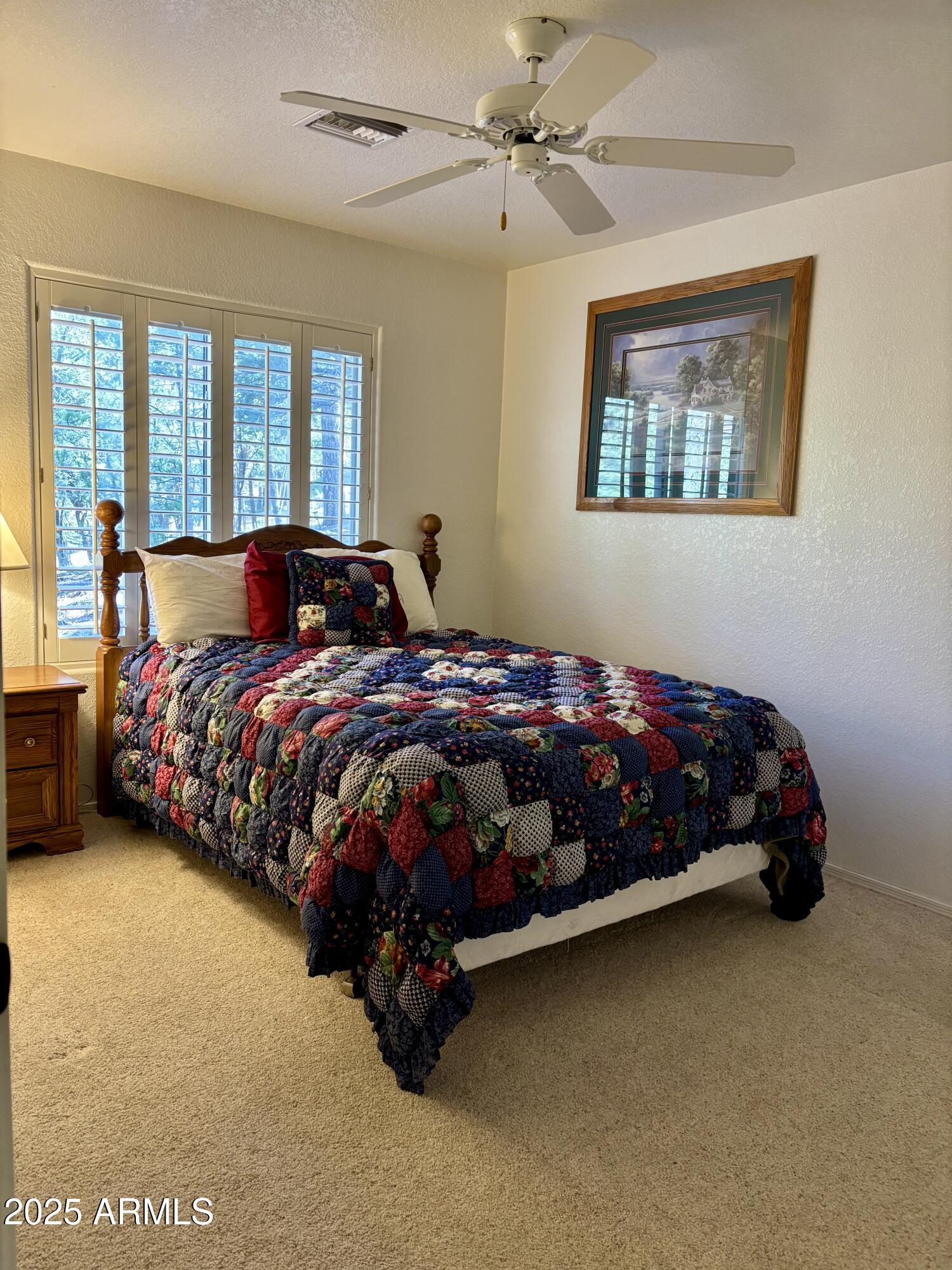 269 Homestead Lane Payson, AZ 85541 - Photo 32 of 38 a bedroom with a bed lamp and a large window