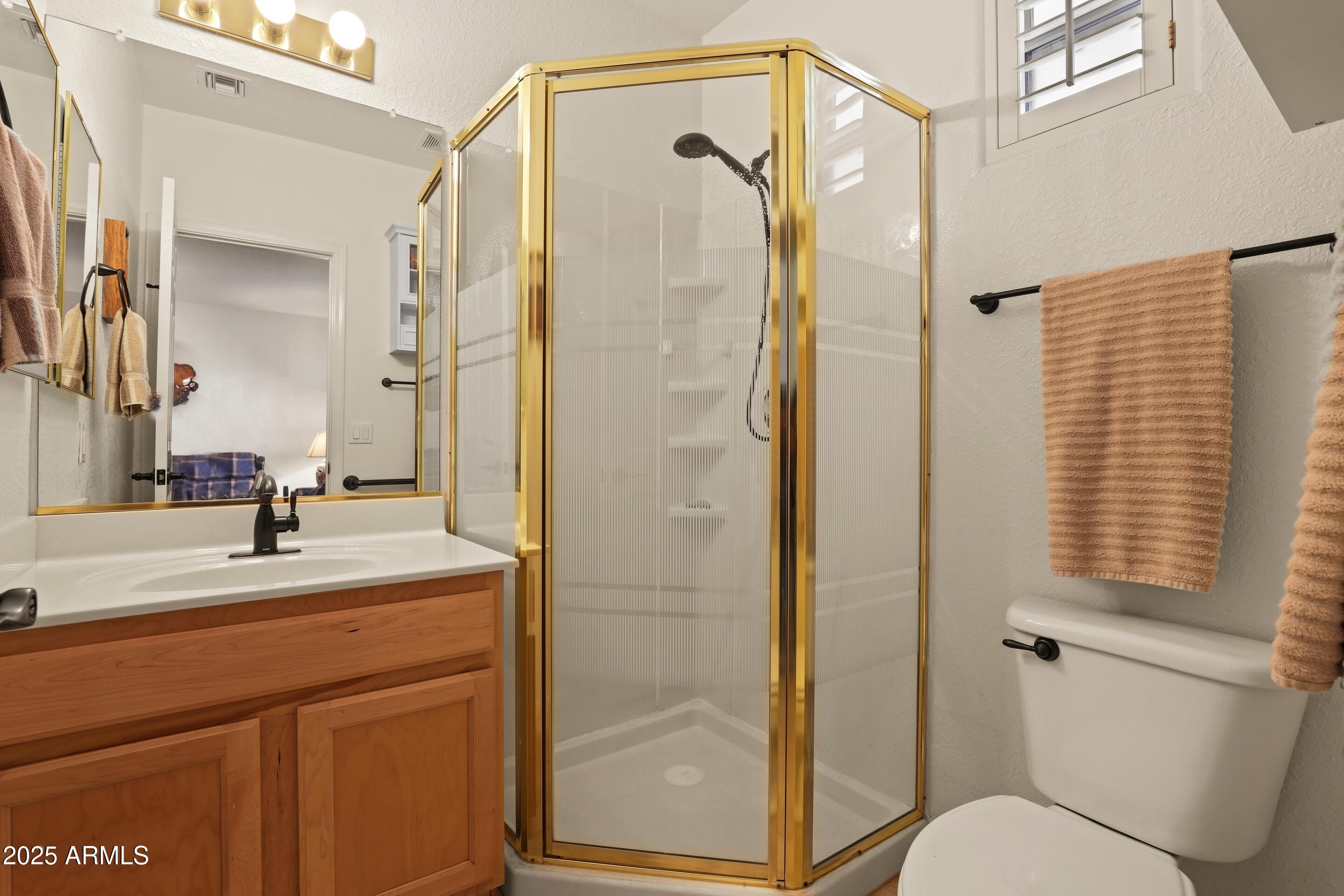 269 Homestead Lane Payson, AZ 85541 - Photo 36 of 38 a bathroom with a granite countertop sink toilet and shower