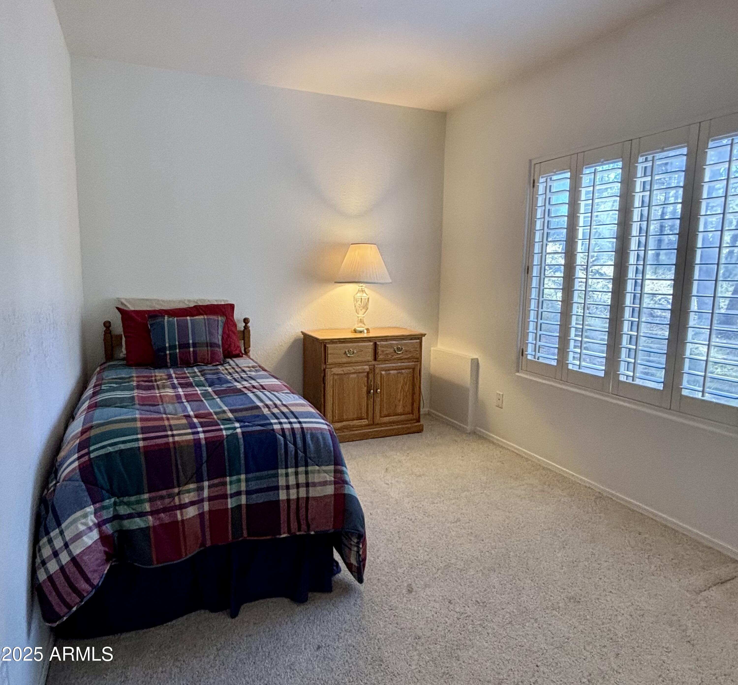 269 Homestead Lane Payson, AZ 85541 - Photo 37 of 38 a bedroom with a bed lamp and window