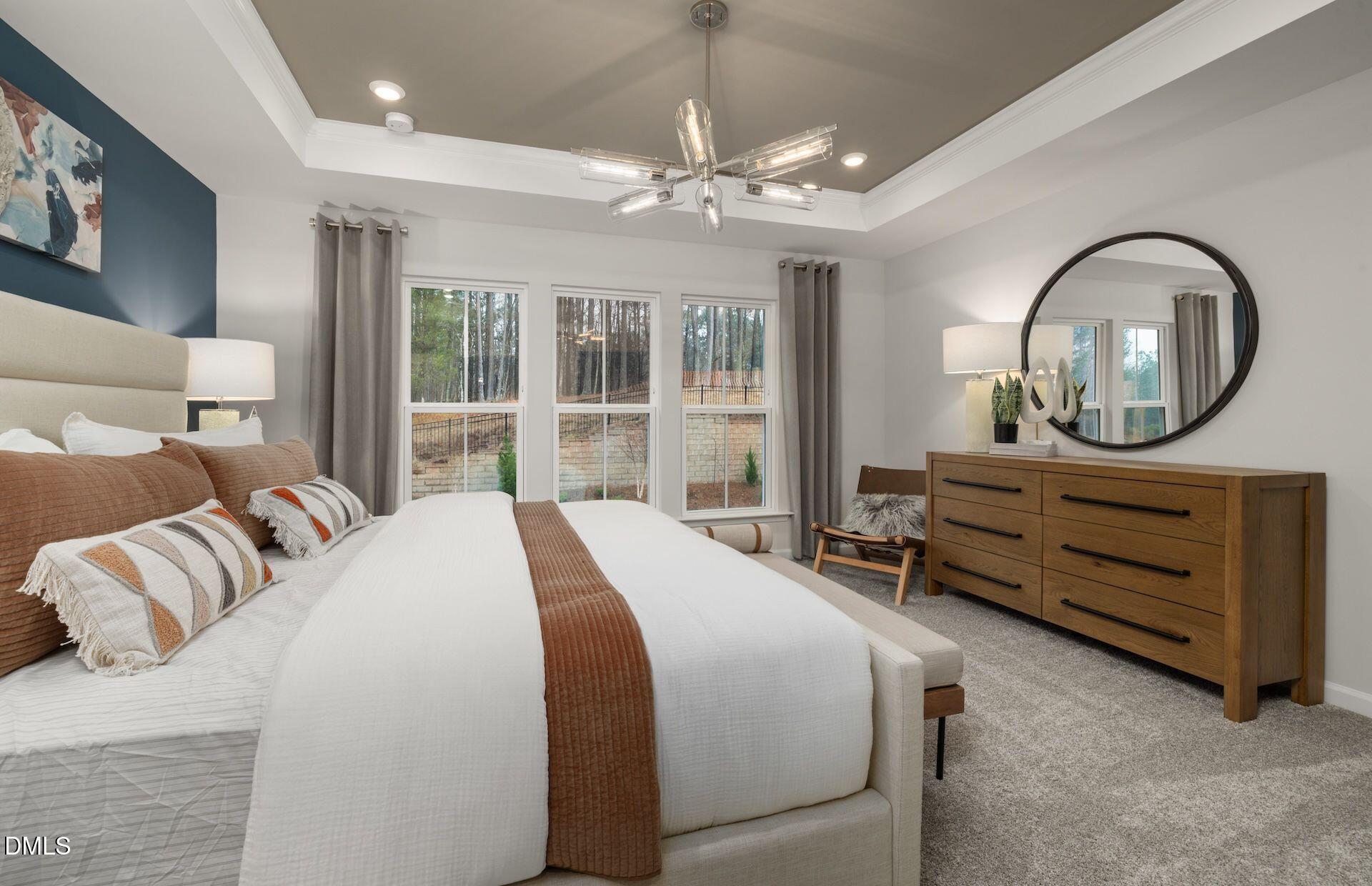 5007 Reader Way Durham, NC 27703 - Photo 10 of 31 a bedroom with a bed and a chandelier