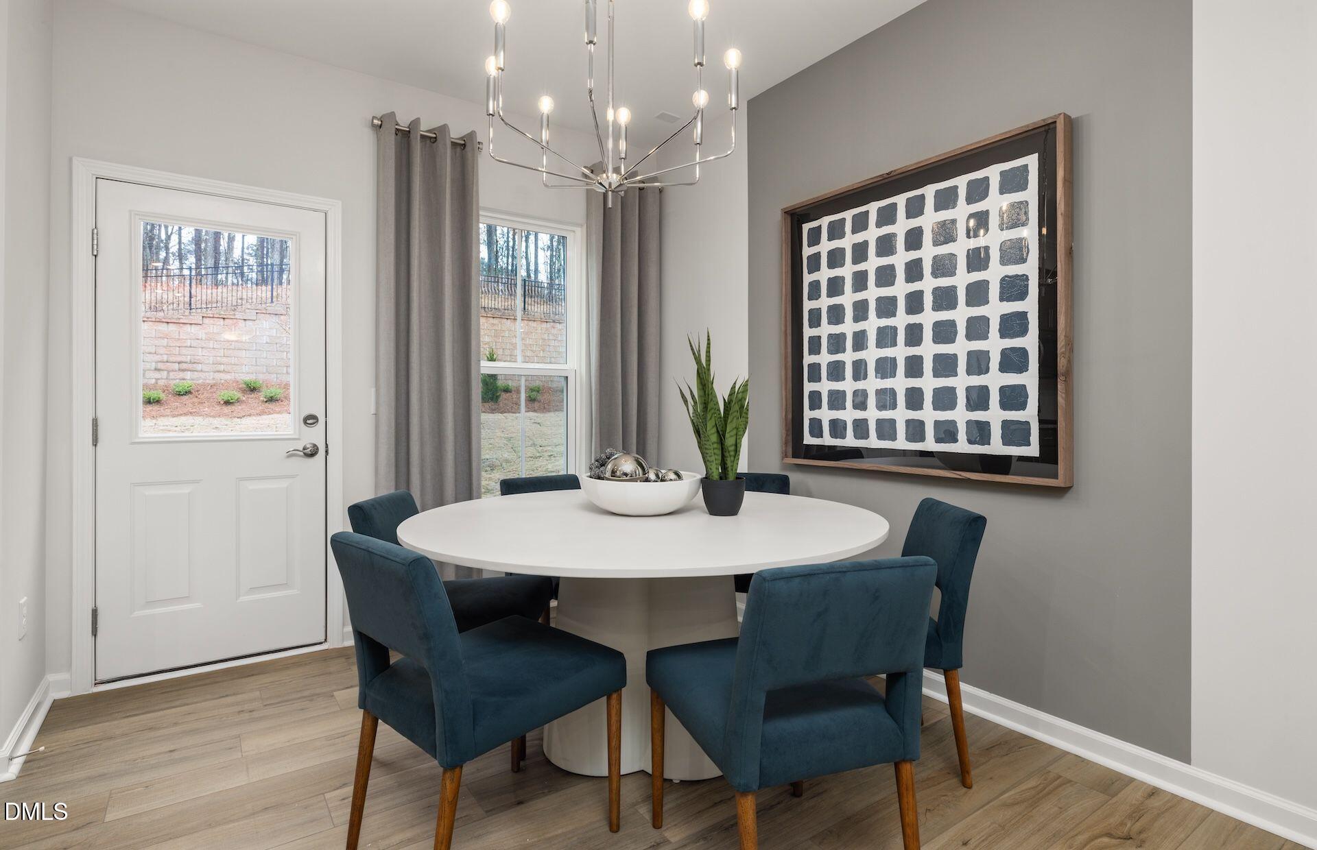 5007 Reader Way Durham, NC 27703 - Photo 6 of 31 a view of a dining room with furniture window and wooden floor