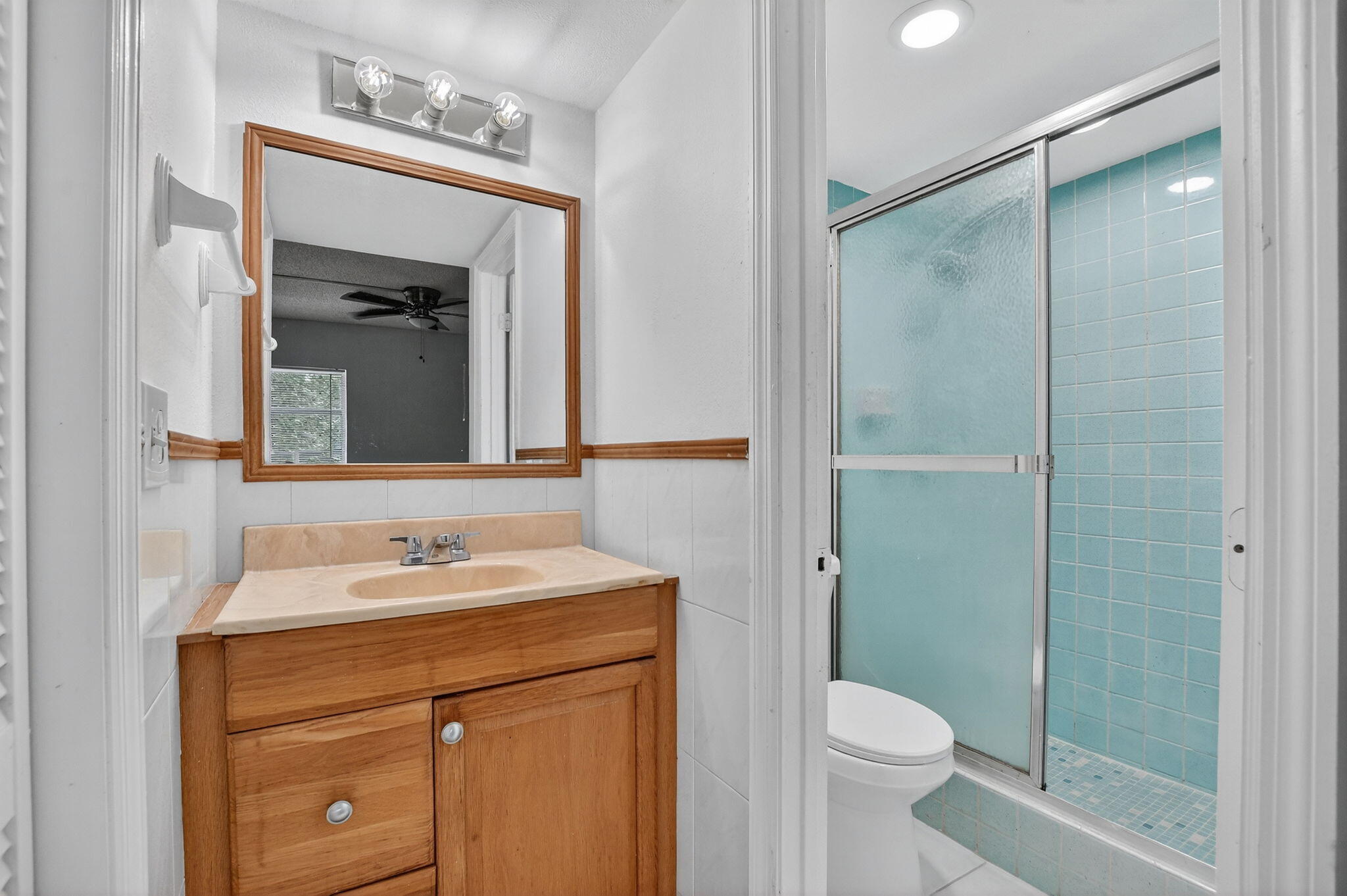 644 Northwest 13th Street, Unit 110 Boca Raton, FL 33486 - Photo 12 of 24 a bathroom with a sink a toilet and shower