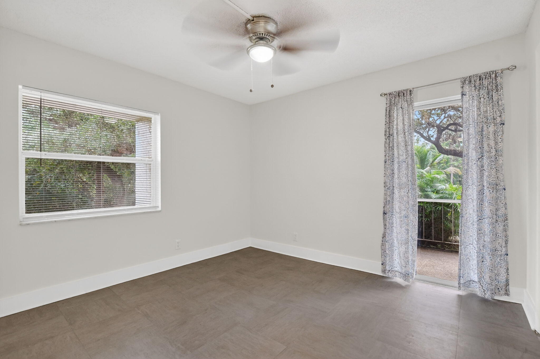 644 Northwest 13th Street, Unit 110 Boca Raton, FL 33486 - Photo 16 of 24 an empty room with a window and a ceiling fan