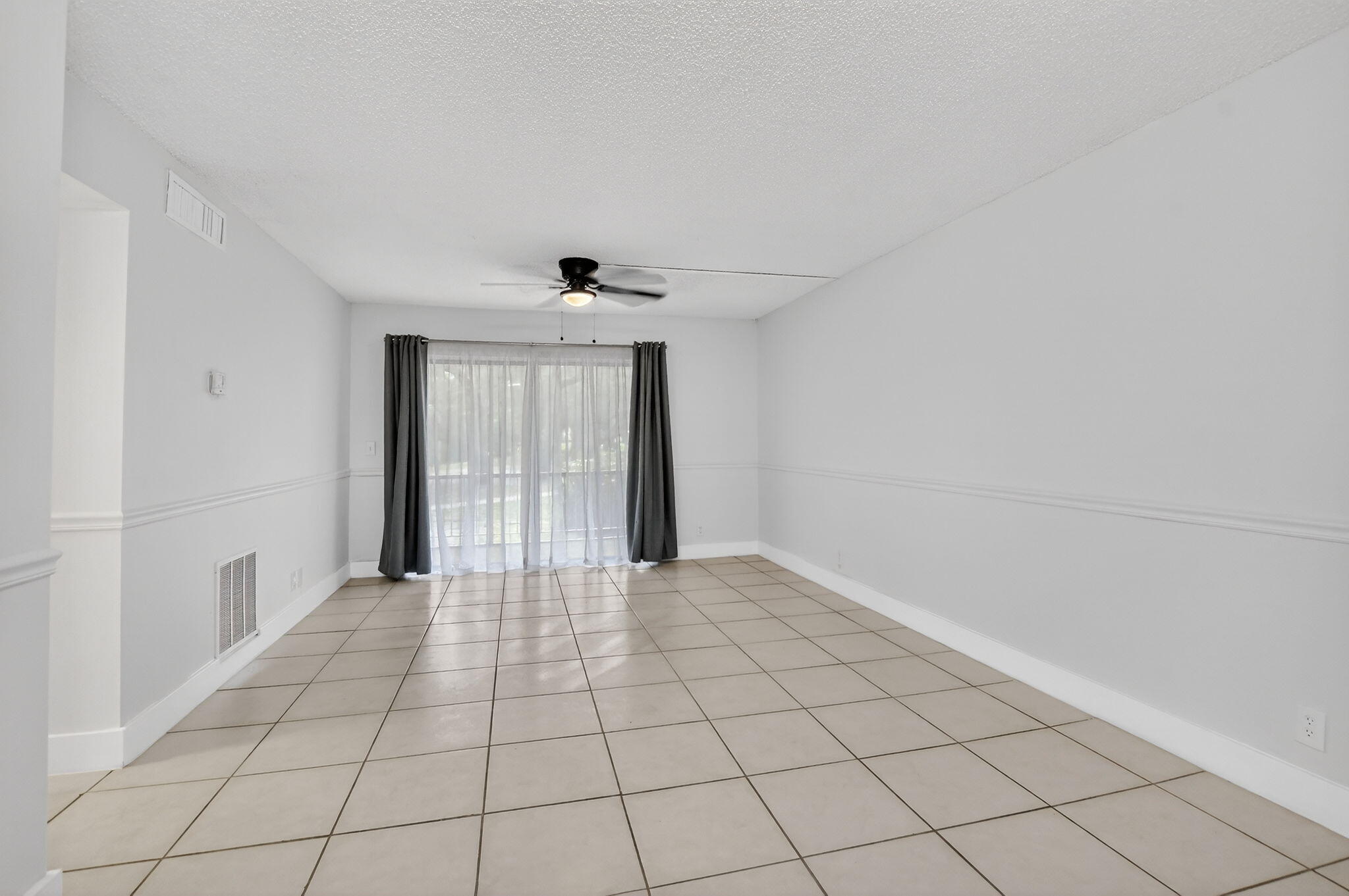 644 Northwest 13th Street, Unit 110 Boca Raton, FL 33486 - Photo 5 of 24 a view of an empty room and window