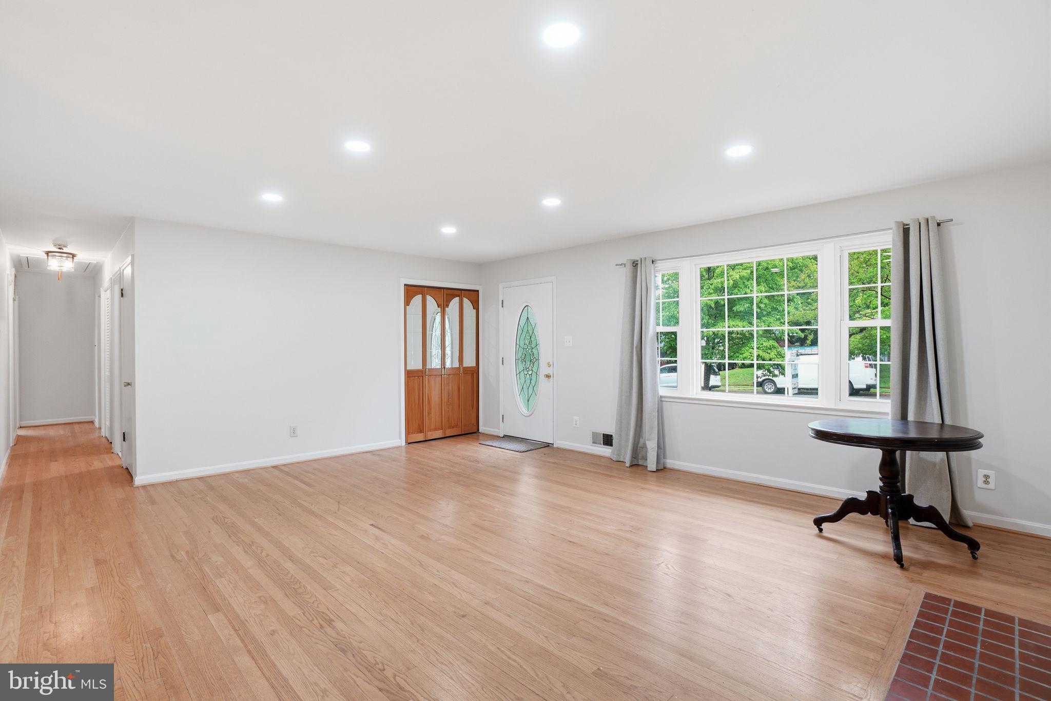 5304 Pillow Lane Springfield, VA 22151 - Photo 6 of 32 a view of an empty room with a window and wooden floor
