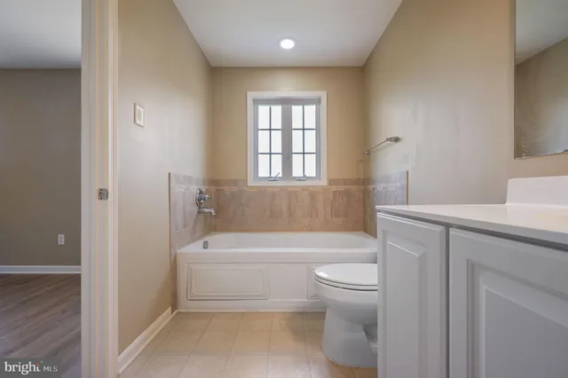a bathroom with a toilet a sink and bathtub