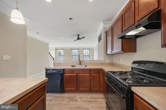 a kitchen with stainless steel appliances granite countertop a sink stove and cabinets