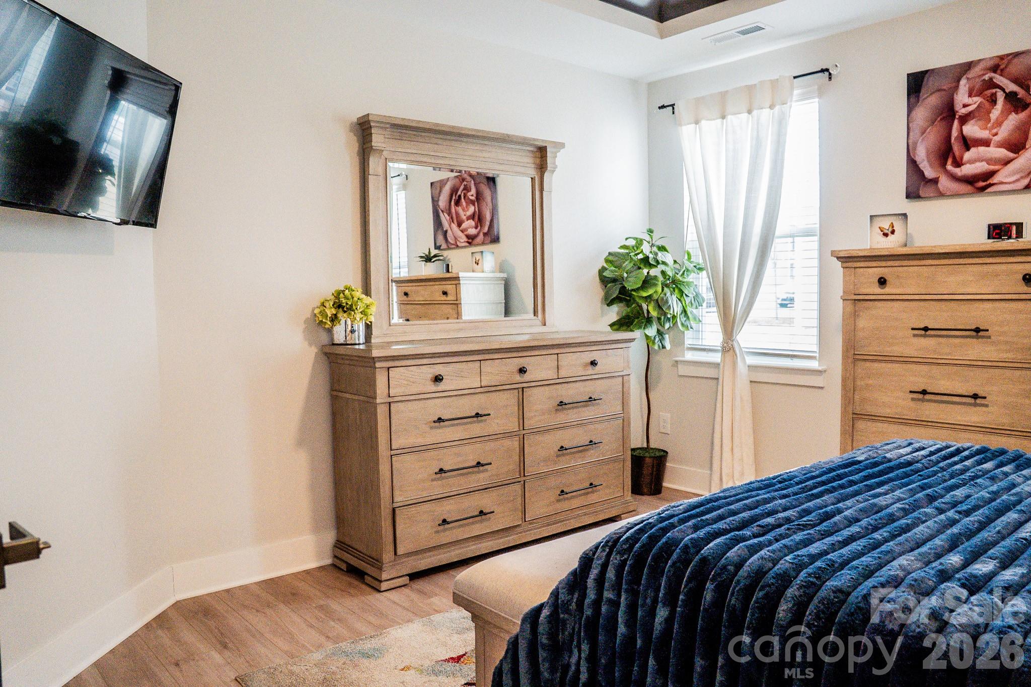 6288 Culbert Street Harrisburg, NC 28075 - Photo 14 of 40 a bedroom with a bed and a flat screen tv