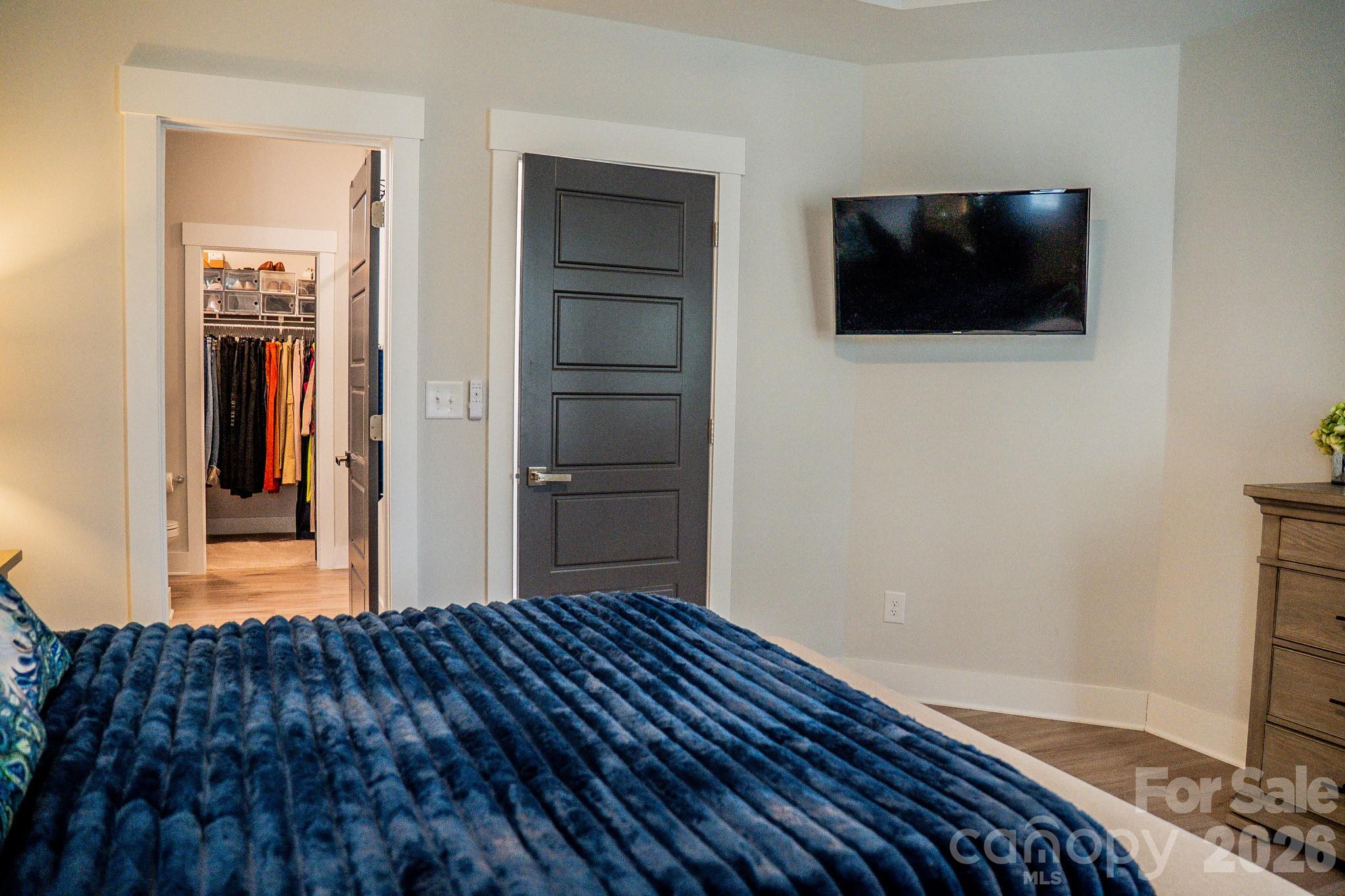 6288 Culbert Street Harrisburg, NC 28075 - Photo 15 of 40 a view of a livingroom with wooden floor and flat screen tv